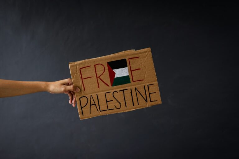 Main tenant un carton avec texte Palestine libre isolé sur fond gris foncé